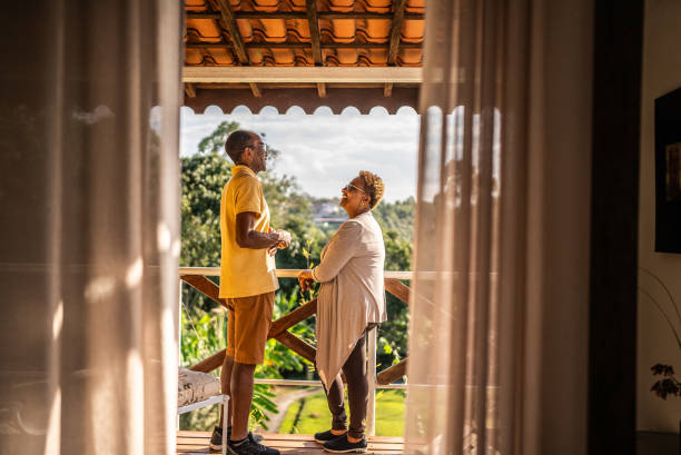 istock Senior couple talking on hotel balcony 1576432328
