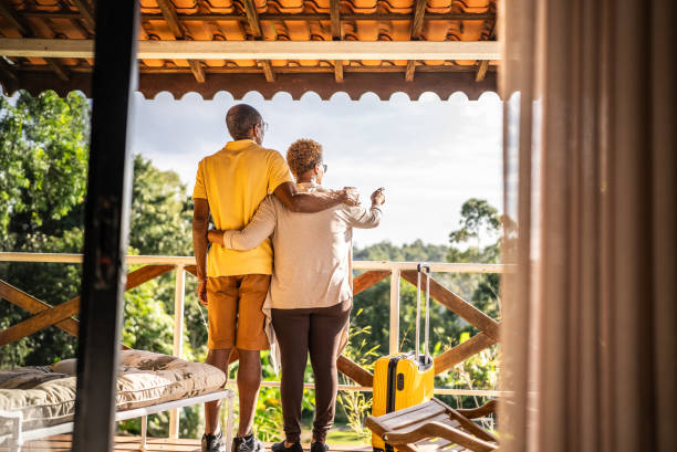 istock Senior couple looking away and relaxing on hotel balcony 1576432348