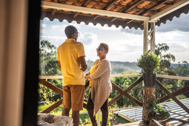 istock Senior couple talking on hotel balcony 1576432350