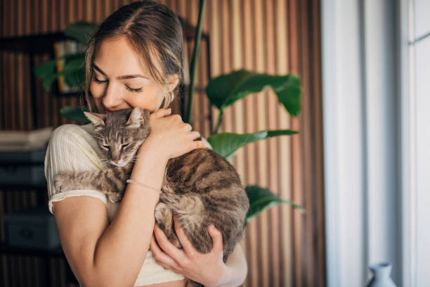 istock Young woman holding a cat 1576432878