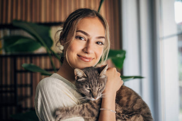 istock Young woman holding a cat 1576432914