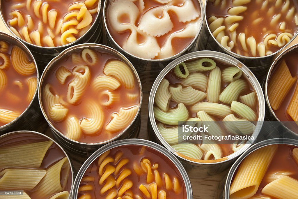 Canned pasta High angle view of lots of cans with variety of pastas in them Canned Food Stock Photo