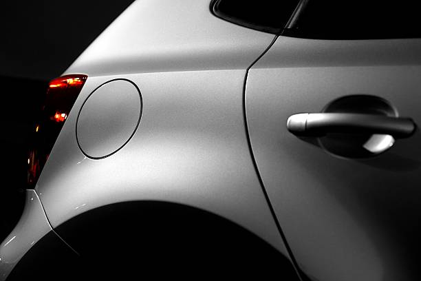 new car at night (under the lantern) close up of a part from a new car at night - low key empty dealership interior stock pictures, royalty-free photos & images