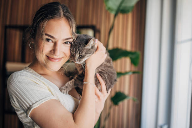 istock Young woman holding a cat 1576433989