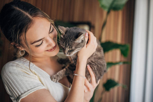 istock Young woman holding a cat 1576434002