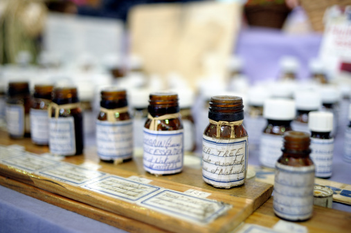 A row of open jars of essential oils at the Provencal Market, le Petit Marche Provencal, Antibes, France. Smells good!