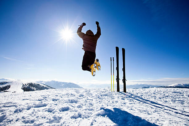 Happy alpine skier jumping in air on the top of alpine ski resort. Click for more similar images: