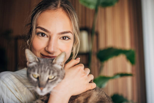 istock Young woman holding a cat 1576434531