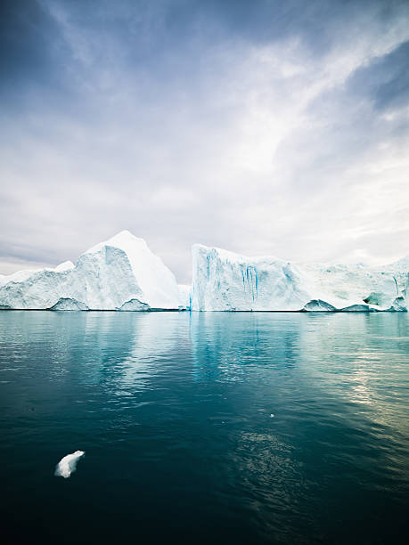 Icebergs in Arctic Waters West Greenland Huge Icebergs drifting in polar arctic icefjord at the west greenland coast. Ilulissat Icefjord, Greenland, North West Coast. north pole photos stock pictures, royalty-free photos & images