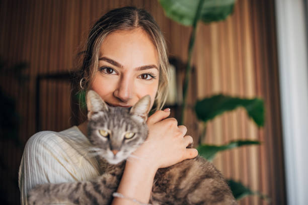 istock Young woman holding a cat 1576435055
