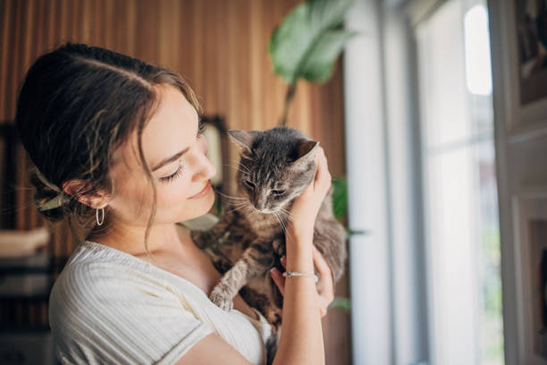 istock Young woman holding a cat 1576435082