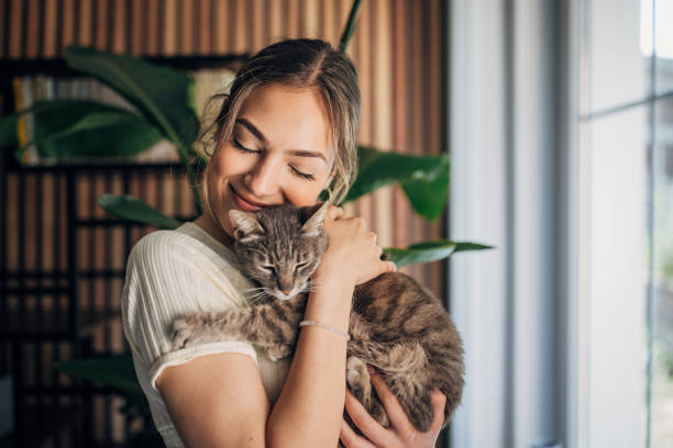 istock Young woman holding a cat 1576435608