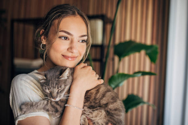 istock Young woman holding a cat 1576435630