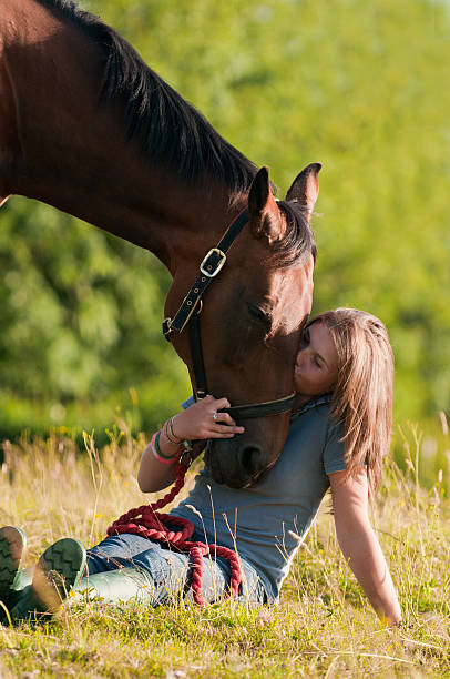 Teenage Girl kissing her horse stock photo