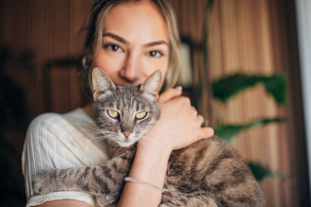 istock Young woman holding a cat 1576436150