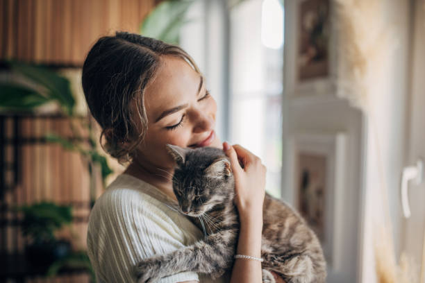istock Young woman holding a cat 1576436178