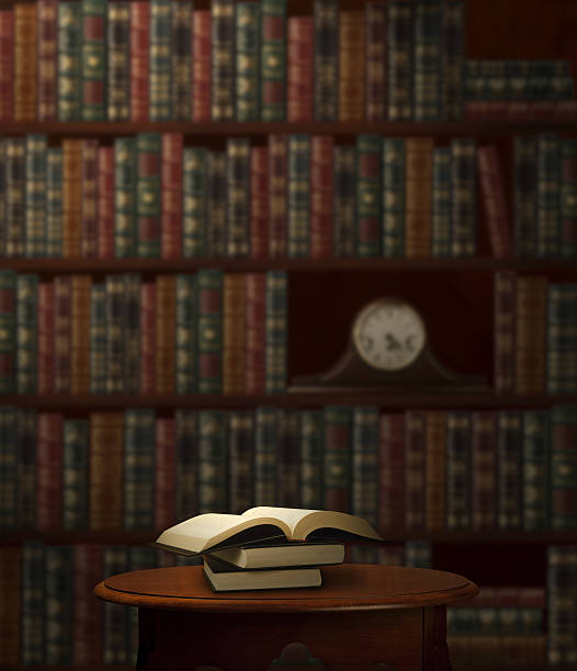 Books Open Book on Small table with Shelved Books in Background. law library stock pictures, royalty-free photos & images