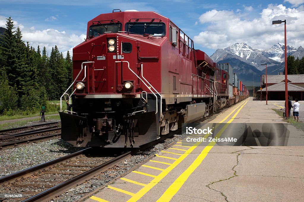 Freight Train With Red Engine Pulling Out Of Station Stock Photo