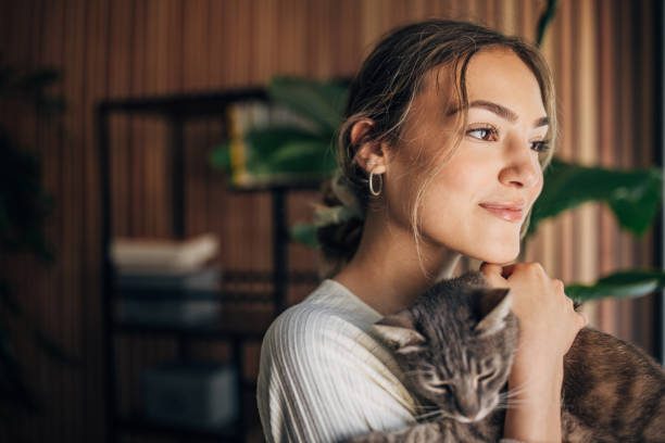 istock Young woman holding a cat 1576436699
