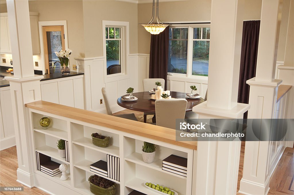 Bookcase divides modern dining room This bookcase divides the dining room and living room. Shelf Stock Photo
