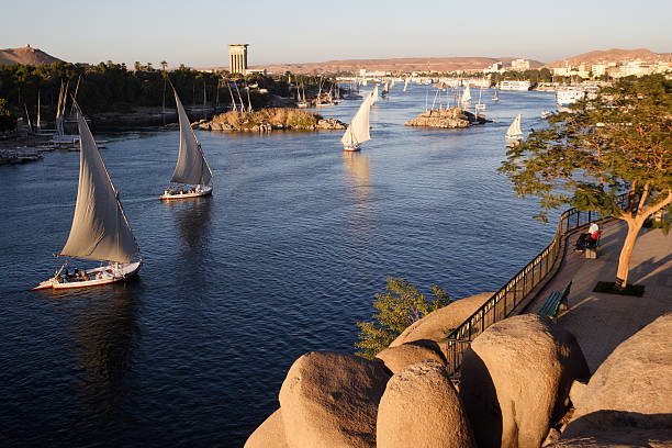 Aswan, Egypt Traditional boats sailing on the Nile river in Aswan, Egypt.     You'll find whatever else you need in this lightbox: Egypt  aswan egypte stock pictures, royalty-free photos & images