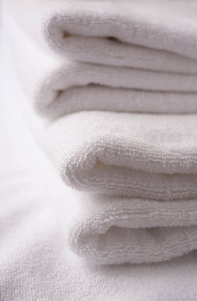 istock Clean white towels folded in a pile 157643779