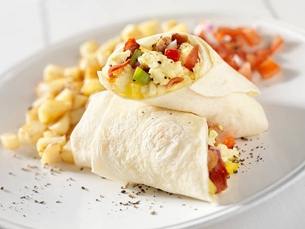 Breakfast Burrito with Hash Brown Potatoes and Salsa Breakfast Burrito with Hash Brown Potatoes and Salsa -Photographed on Hasselblad H3D2-39mb Camera burrito stock pictures, royalty-free photos & images