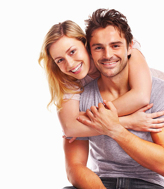 istock Young beautiful woman embracing a man isolated on white 157644316