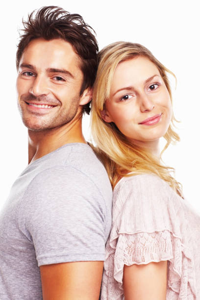 istock Smiling handsome man and woman standing against white 157644318