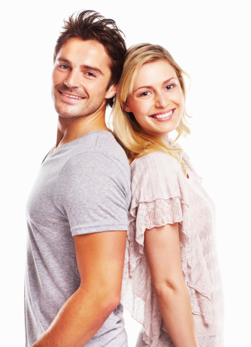 Portrait of beautiful mature couple standing together smiling at camera against white background