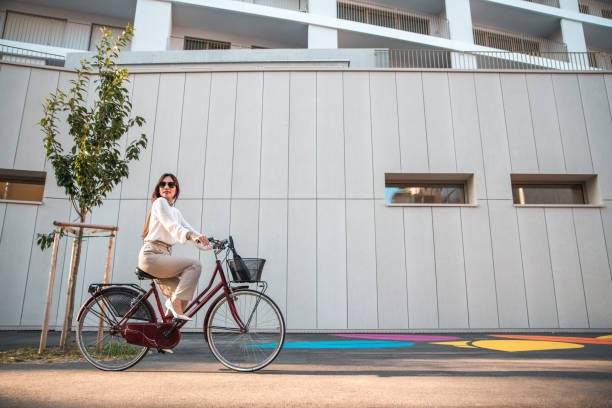 istock Asian Businesswoman Riding A Bicycle To Work 1576443891
