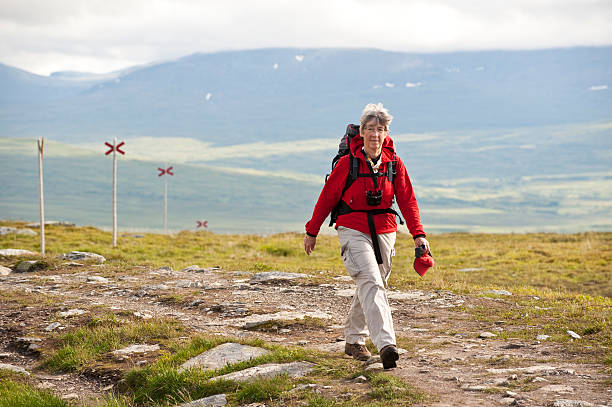 Relaxed female hiker with backpack stock photo
