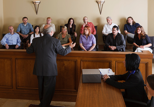A lawyer in a courtroom talking to the jury.