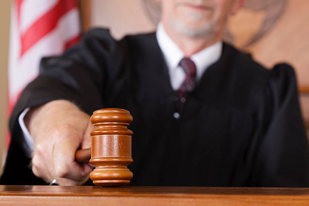 Close-up of a Judge's Gavel A close-up of a judge's gavel in his hand in the courtroom. judges stock pictures, royalty-free photos & images