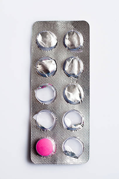 Blister pack with one pink pill remaining, close-up stock photo