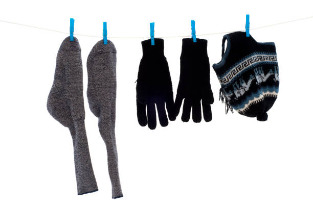 close-up view of clean white socks hanging on clothesline isolated on blue