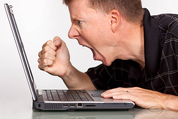 Angry man with laptop computer – fist stock photo