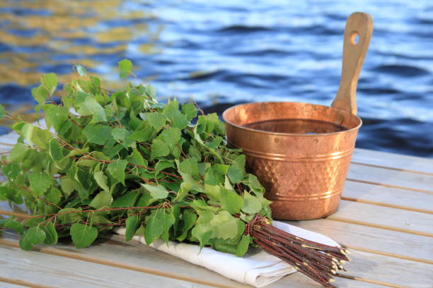 Finnish Sauna Equipment A bucket of water and a bunch of birch twigs ("vasta"). Vasta is used in traditional Finnish sauna bathing for stimulation of the skin. finnish culture stock pictures, royalty-free photos & images