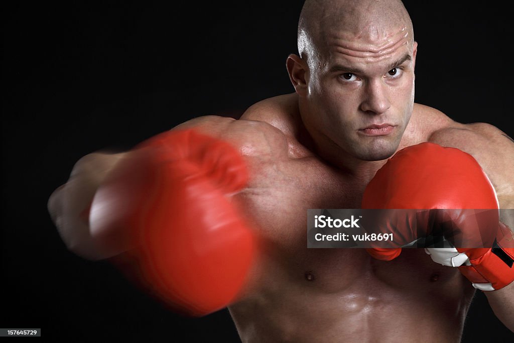 Dangerous fighter in action Dangerous fighter in action-isolated on black background Abdomen Stock Photo