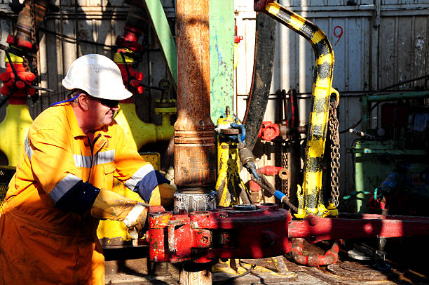 istock Drilling rig worker wearing a white hard hat and safety gear 157645888