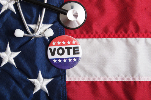 an american voting pin with a usa flag and a stethoscope. 