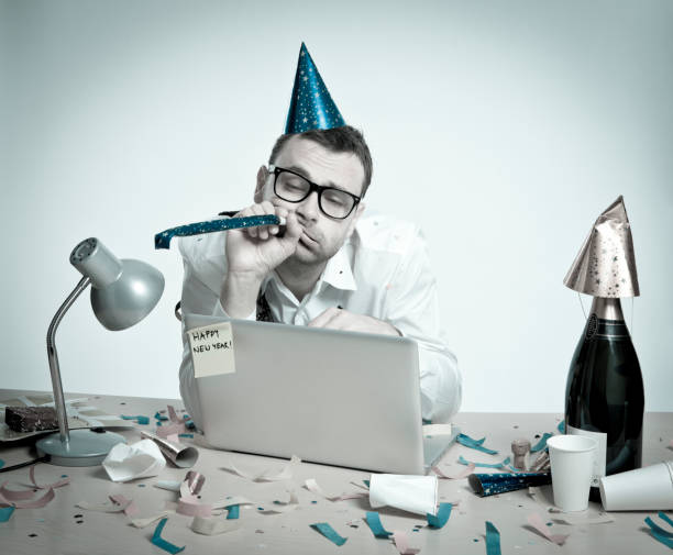 istock Happy New Year, hungover man behind laptop, office interior, retro 157646043