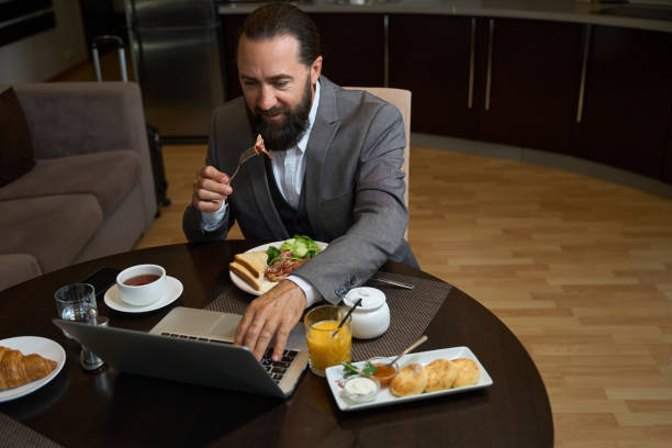 istock Bearded man has breakfast in a hotel room 1576460826