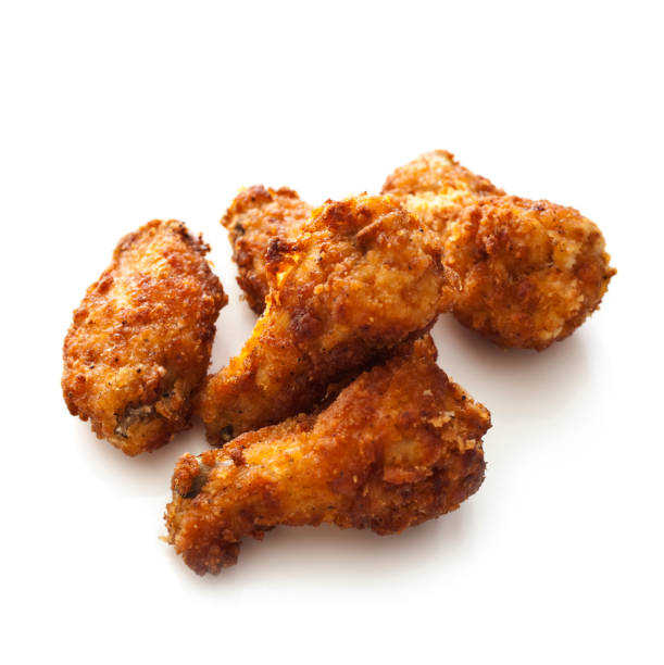 Batch of cooked chicken wings isolated on white