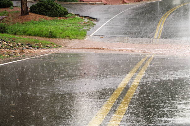 Flooded Road Hail Storm Flooded road caused by heavy rain and hail. tropical storm photos stock pictures, royalty-free photos & images