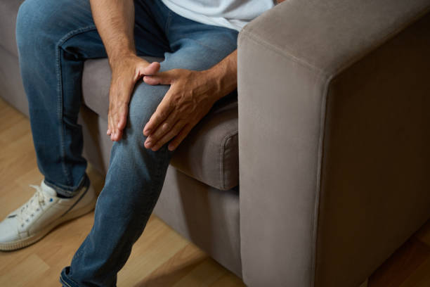 istock Man in casual clothes suffers from knee pain 1576462048