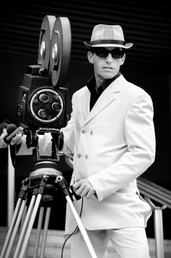 Monochrome retro portrait of a camera operator. Paparazzi.