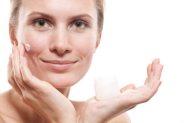 istock Woman applying moisturizer cream on face. 157646512