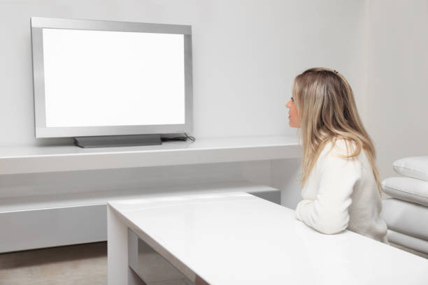 istock Young cute blonde watching TV in white sitting room 157646664