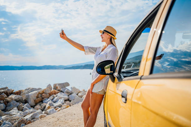 istock Woman taking a selfie on the beach 1576468624
